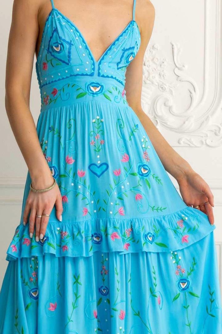Blue dress with floral and heart patterns on a white background