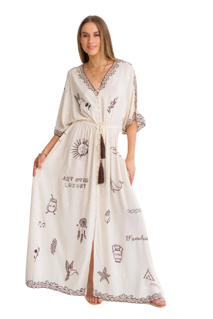 Woman wearing a white dress with black patterns on a white background