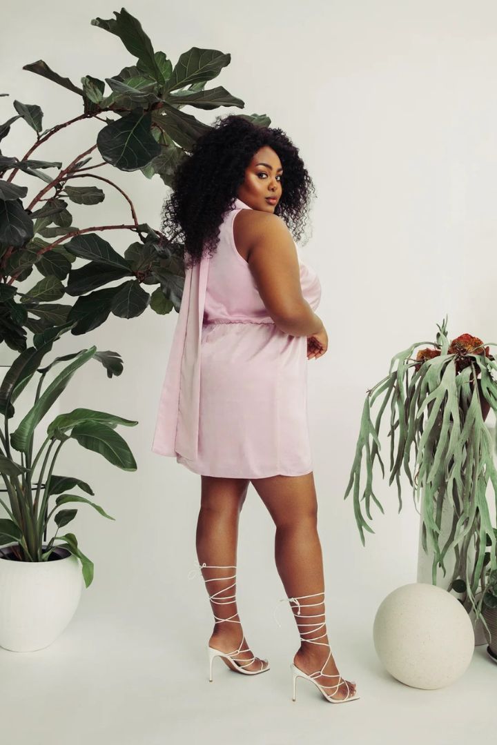 Model wearing Hilary MacMillan bowed halter dress back view