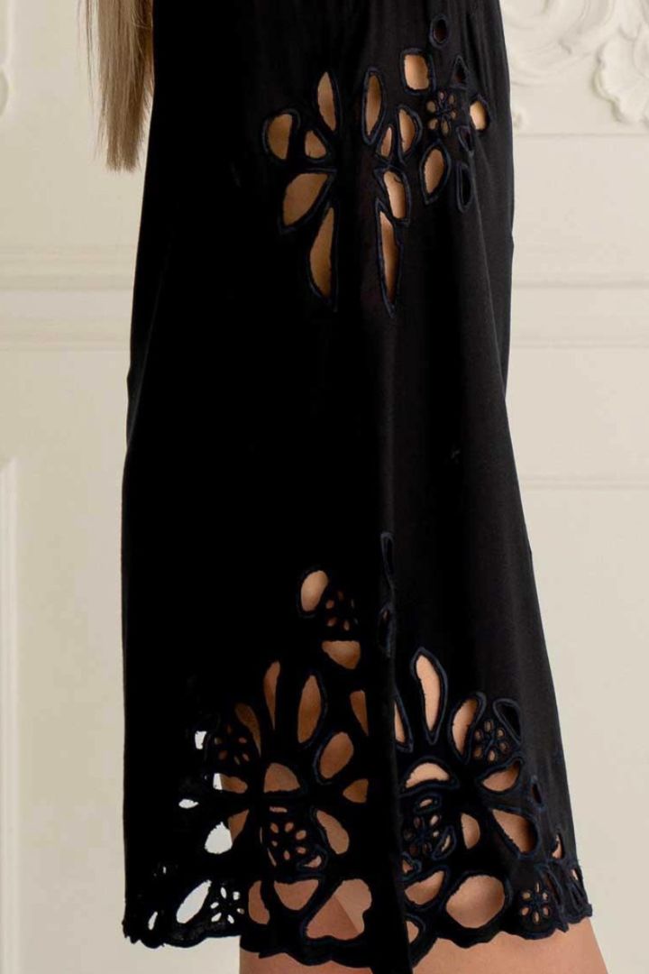 Black dress with floral cut-out details on a white background