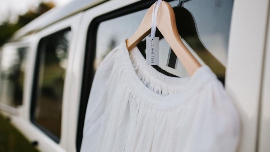 white shirt on hange outdoors on reflective glass