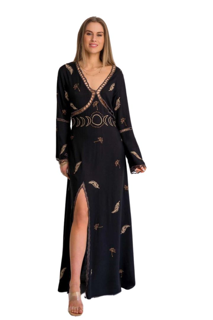 Woman wearing a black dress with gold patterns on a white background