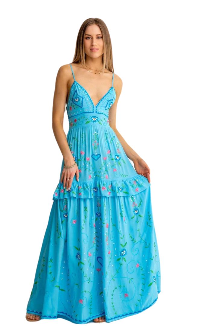 Woman wearing a blue floral dress on a white background