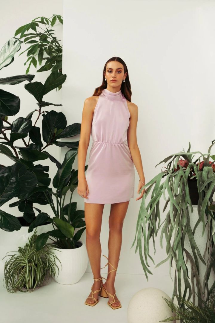 Model wearing Hilary MacMillan bowed halter dress