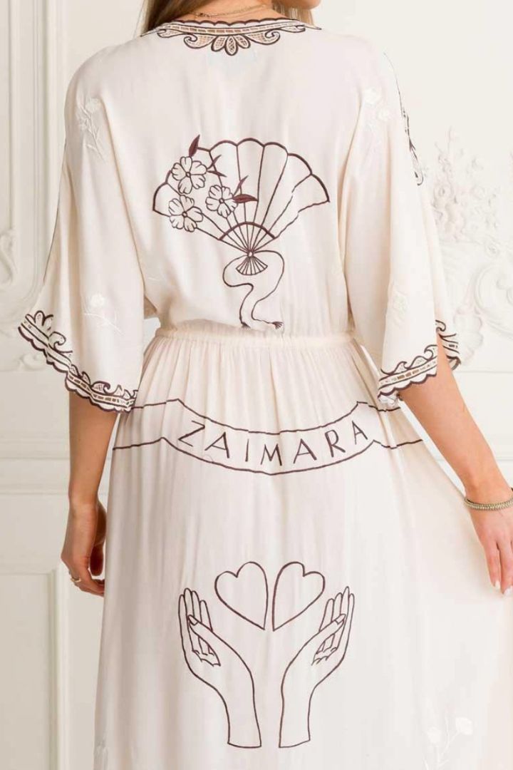 White dress with black embroidery and 'Zaimara' branding on a white background