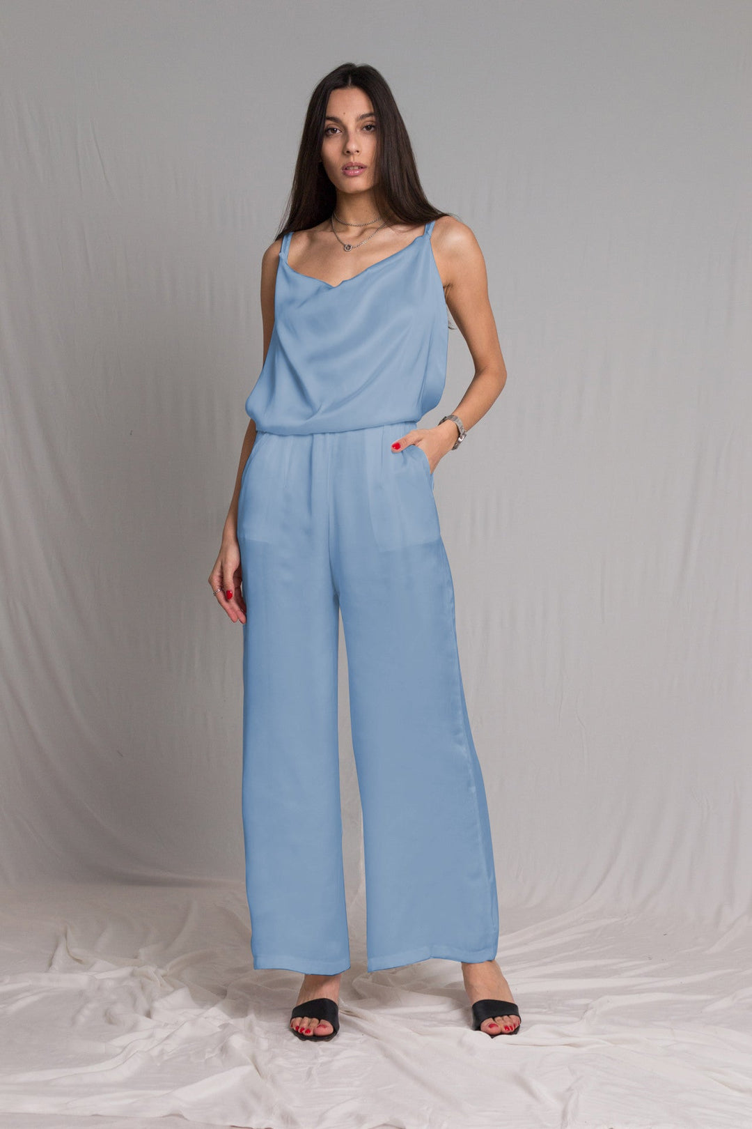 Baby blue satin jumpsuit with a cowl neckline thin straps and a risque low back