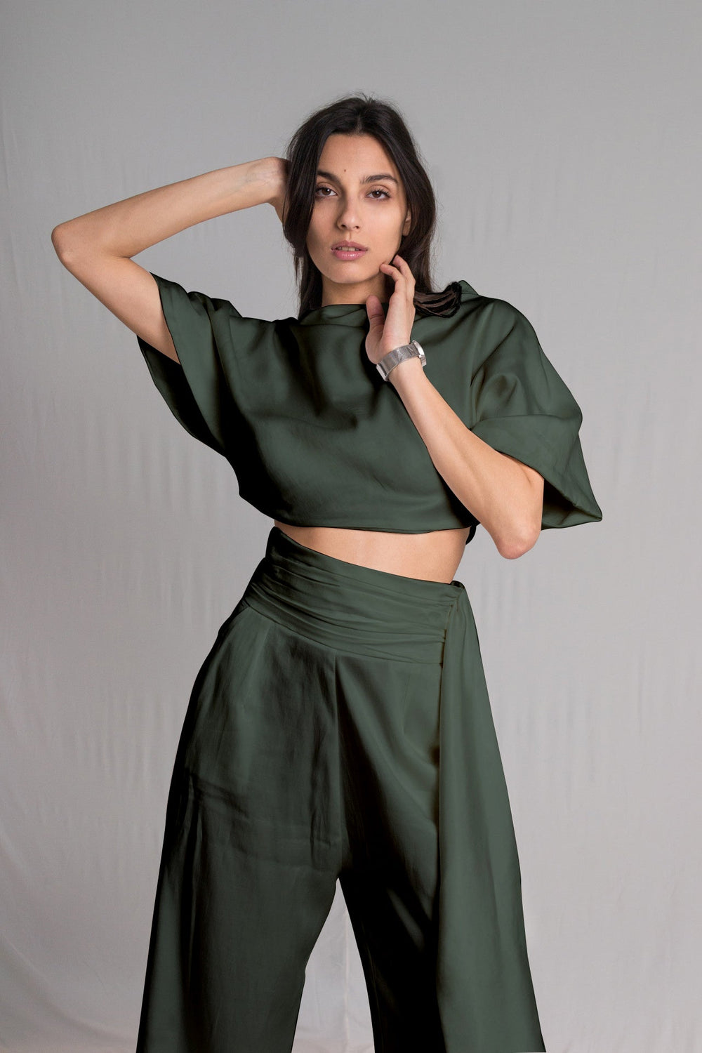 Olive green cropped top with a relaxed cowl neckline and high-waist pants with a hidden zipper pockets and a hand-ruched waistband