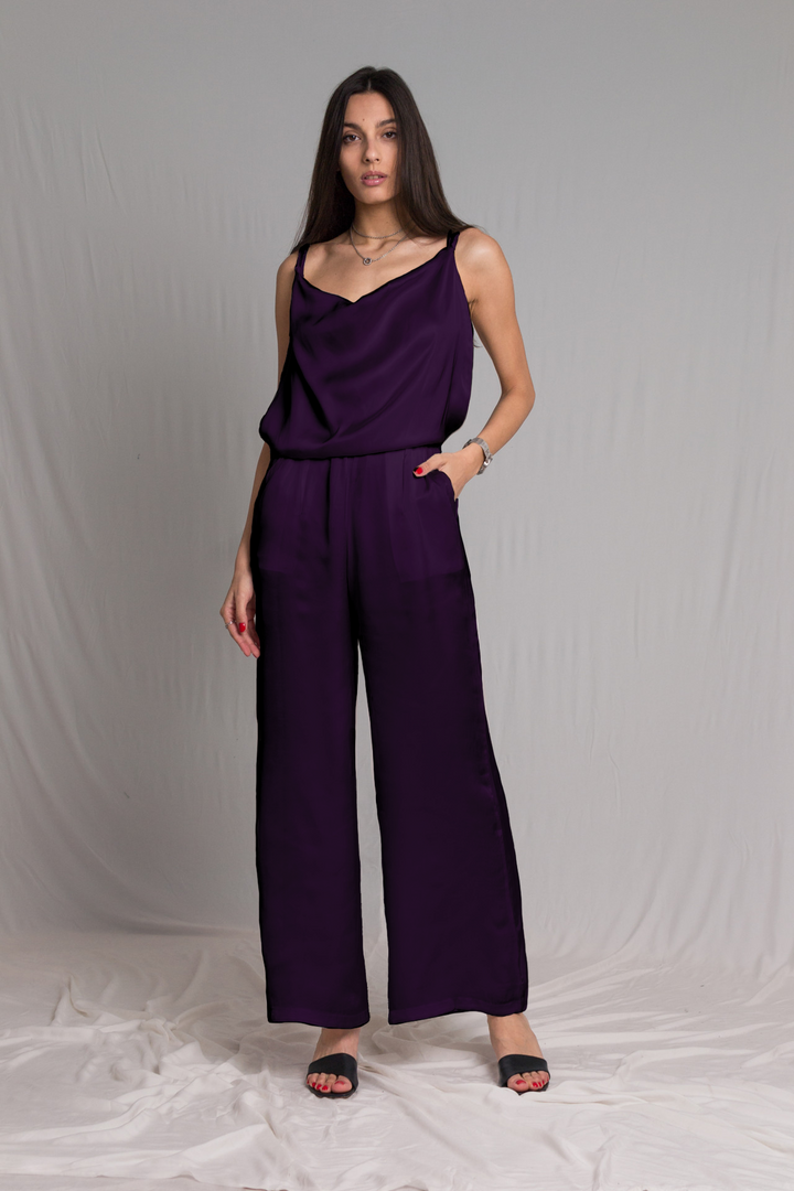 purple satin jumpsuit with a cowl neckline thin straps and a risque low back