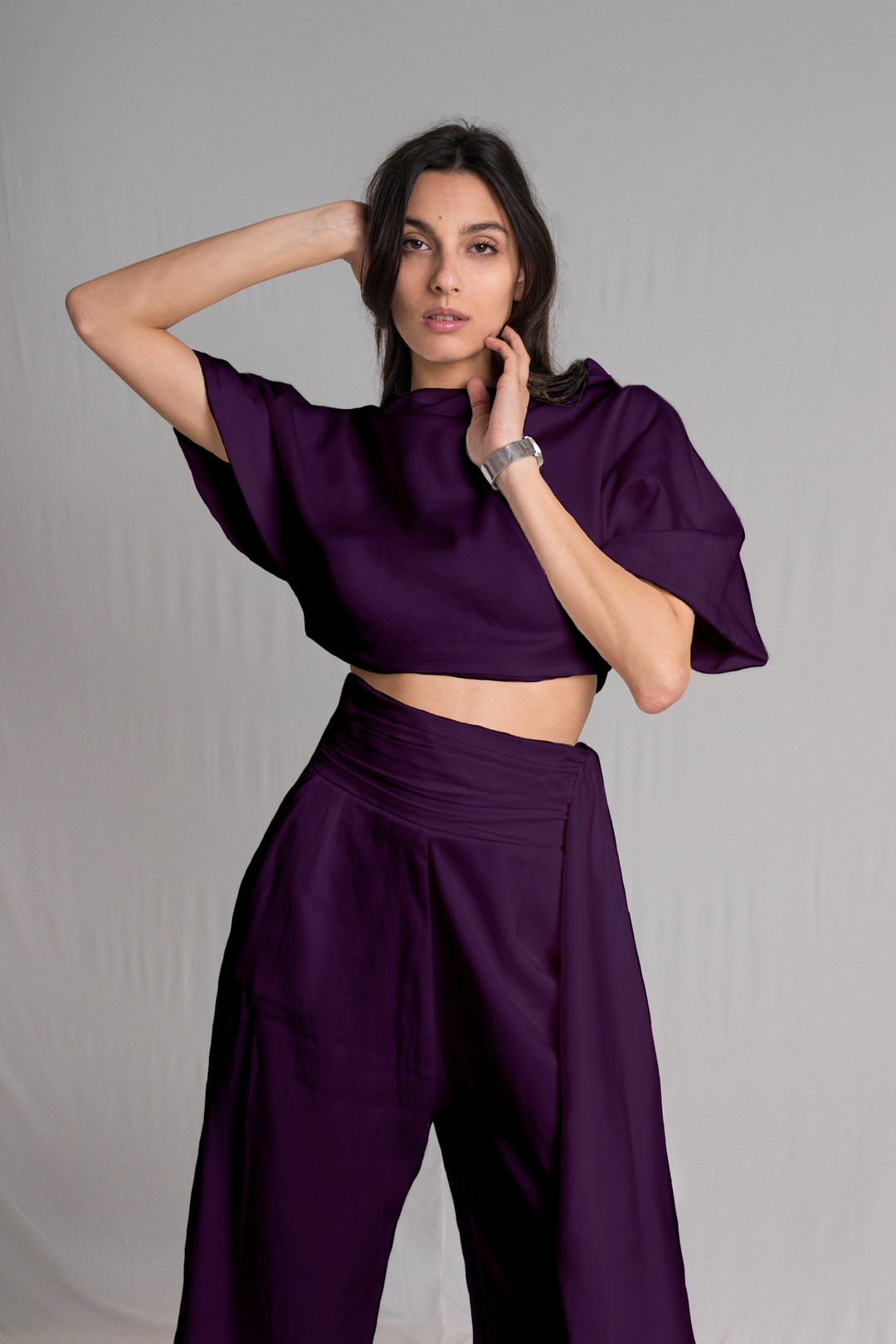 Purple cropped top with a relaxed cowl neckline and high-waist pants with a hidden zipper pockets and a hand-ruched waistband